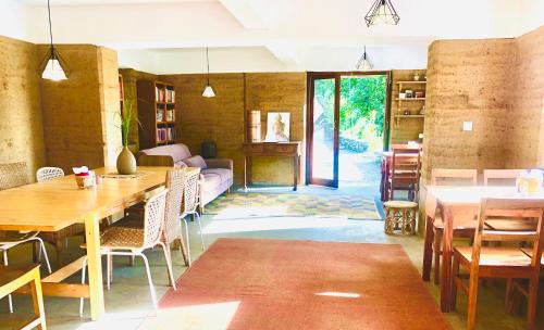 a room with tables and chairs and a living room at Resort Vishuddhialaya Pvt Ltd in Dhulikhel