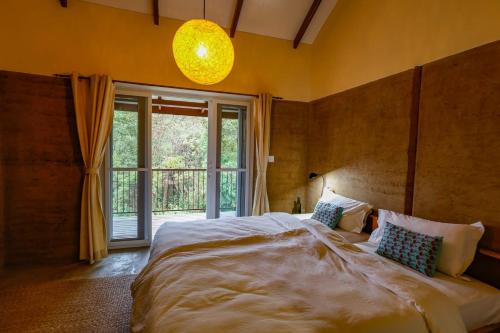 a bedroom with a large bed and a large window at Resort Vishuddhialaya Pvt Ltd in Dhulikhel