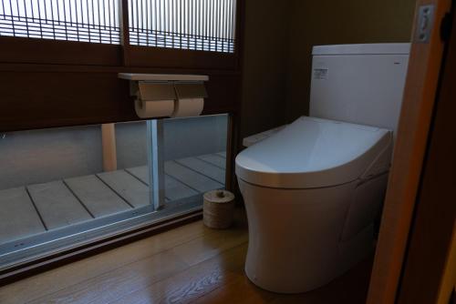 a bathroom with a toilet in a small room at Ryokan Kiraku in Beppu