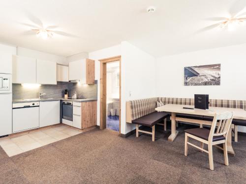 a kitchen and dining room with a table and chairs at Leni Mountain Appartements in Sölden