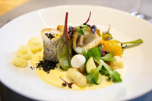 a plate of food on a white plate at HVD Grand Hotel Suhl Business & Leisure in Suhl