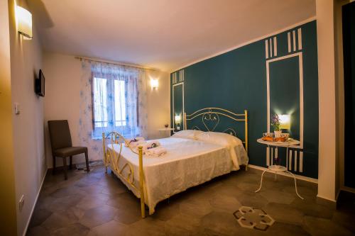 a bedroom with a bed and a chair and a window at Marghaerita B&B in Cetraro