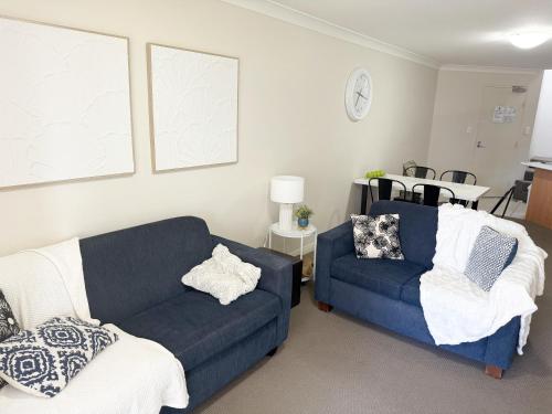 a living room with a couch and a chair at Sandcastles On The Broadwater in Gold Coast