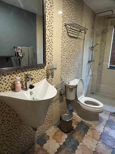 a bathroom with a sink and a toilet and a mirror at Hua hin pool view in Hua Hin