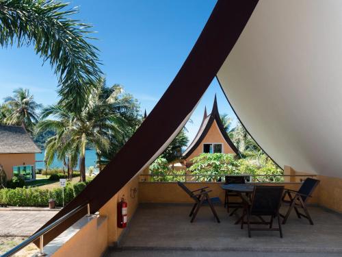 a view from the balcony of a house with a table and chairs at Windy Villa by Utalay Koh Chang in Ban Khlong Son