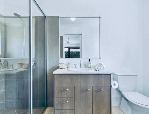 a bathroom with a shower and a sink and a toilet at House 4-bed 2-bath Caboolture South in Caboolture