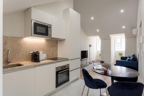 a kitchen and dining room with a table and chairs at Lisbon Nest 2BR in Lisbon
