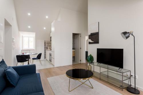 a living room with a blue couch and a tv at Lisbon Nest 2BR in Lisbon