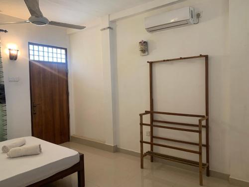 a room with a bed and a chalkboard on the wall at New Papa Palace in Wattegama