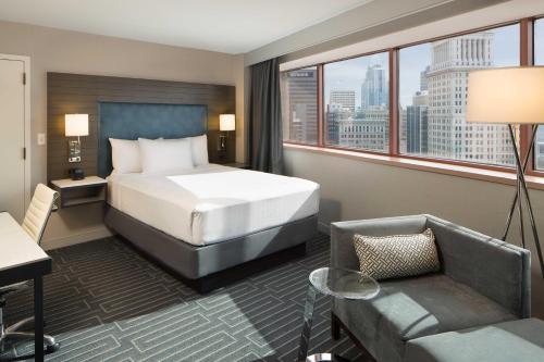 a hotel room with a bed and a large window at Hyatt Regency Cincinnati in Cincinnati