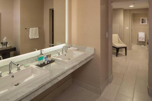 a bathroom with two sinks and a large mirror at Hyatt Regency Cincinnati in Cincinnati