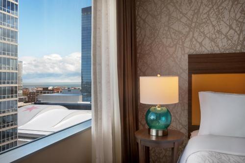 a bedroom with a bed and a window with a view at Home2 Suites By Hilton Chicago McCormick Place in Chicago