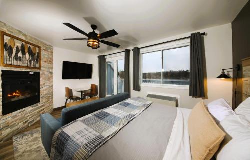 a bedroom with a bed and a couch and a fireplace at Bayview Wildwood Resort, an Ascend Collection Resort in Severn