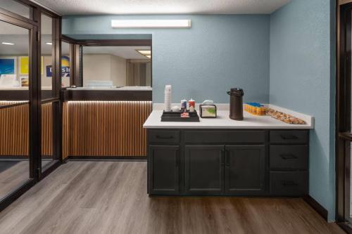 a kitchen with a counter with a coffee maker on it at Days Inn by Wyndham Kansas City Northeast in Kansas City