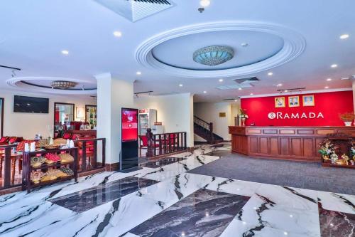 a lobby of a store with a marble floor at Ramada by Wyndham Phnom Penh Central in Phnom Penh