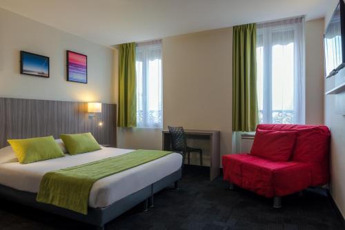 a hotel room with a bed and a red chair at Reims Hotel in Paris