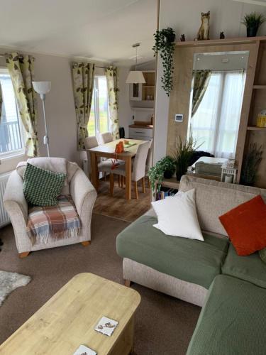 a living room with a couch and a table at The Brend - Seaview holiday home in Newbiggin-by-the-Sea