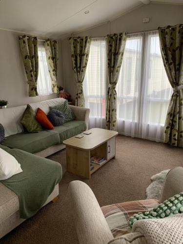 a living room with two couches and a coffee table at The Brend - Seaview holiday home in Newbiggin-by-the-Sea