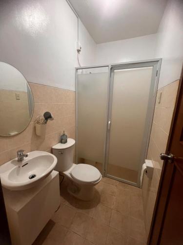 a bathroom with a toilet and a sink and a shower at 2-Storey with 4BR Villa in a High-End Subdivision in Davao City