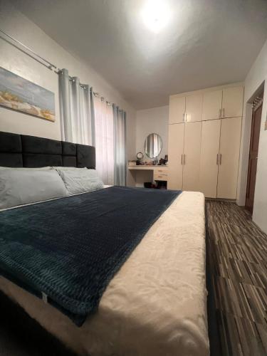 a bedroom with a large bed with a black blanket at 2-Storey with 4BR Villa in a High-End Subdivision in Davao City