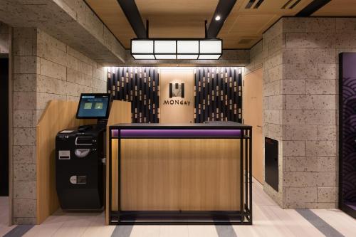 a lobby with a museum sign and a refrigerator at MONday Apart Hamamatsucho Daimon in Tokyo