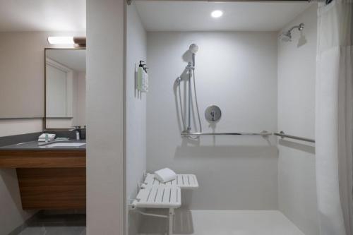 a white bathroom with a shower and a sink at Fairfield by Marriott Inn & Suites Clinton in Clinton