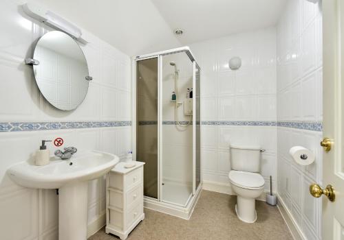 a bathroom with a sink toilet and a shower at The Steading at Pitmeadow Farm in Dunning