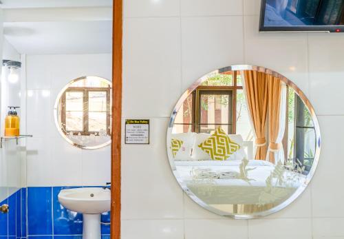 a bathroom with a mirror and a sink at De Bua Valley Resort in Wang Nam Khieo
