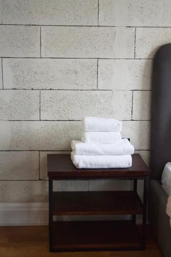 a pile of towels on a table next to a wall at ЖК Esentai city in Almaty