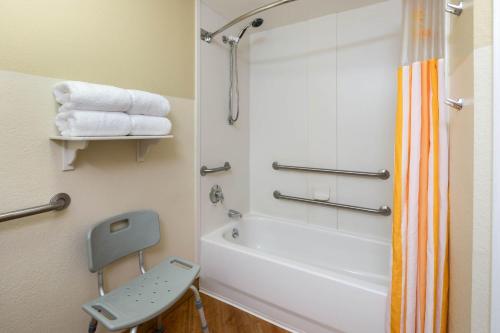 a bathroom with a shower and a tub and a sink at La Quinta by Wyndham Haywood Mall-Near Greenville Downtown in Greenville
