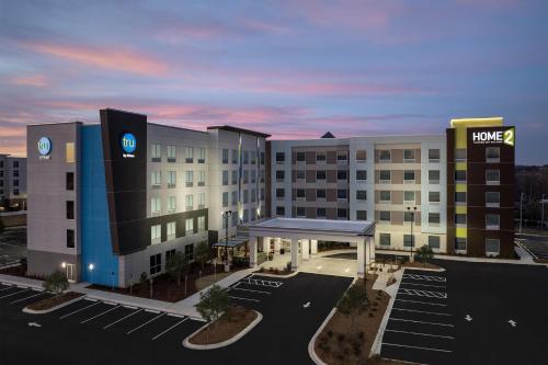 a rendering of a hotel with a parking lot at Tru By Hilton Concord Charlotte in Concord