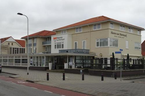 
a large building with a sign on the side of it at Heeren van Noortwyck in Noordwijk aan Zee
