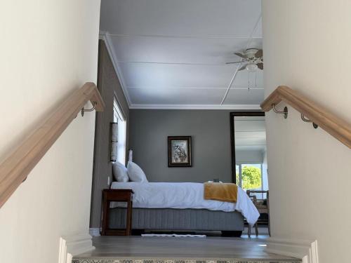 a bedroom with a bed and a ceiling fan at Mia Nina in Heatherlands