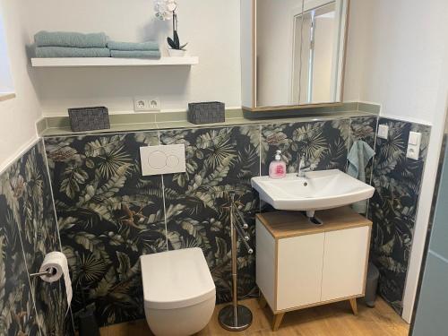 a bathroom with a sink and a toilet at OK-City in Bayreuth