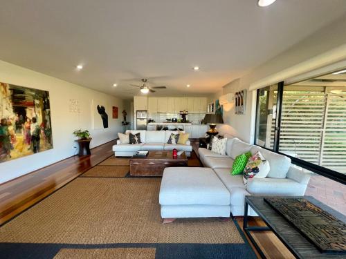 a living room with two couches and a table at Perfect weekend getaway plus golf at your doorstep in Salamander Bay