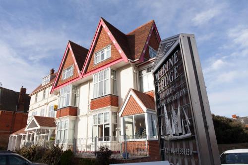 a large house with a sign in front of it at Marine Lodge in Great Yarmouth