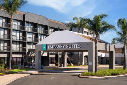 an entrance to an embassy suites hotel with palm trees at Embassy Suites San Luis Obispo in San Luis Obispo