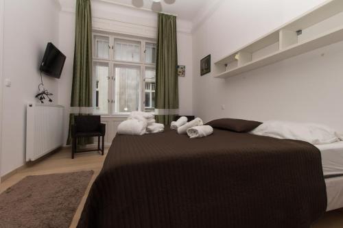 a bedroom with a bed with stuffed animals on it at Butterfly Home Danube in Budapest
