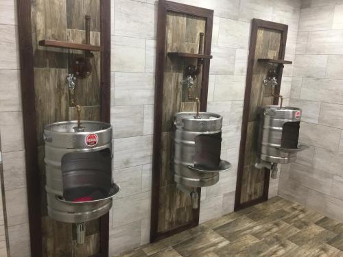 a group of three toilets in a room at Picanha Grill Guest House & Events Venue in Nigel