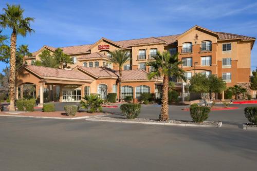 a hotel with palm trees in front of a street at Hilton Garden Inn Las Vegas Strip South in Las Vegas
