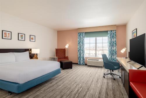 a hotel room with a bed and a desk at Hilton Garden Inn Las Vegas Strip South in Las Vegas