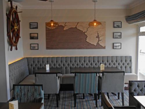 a dining room with a map on the wall at The Cottage Hotel in Hope-Cove