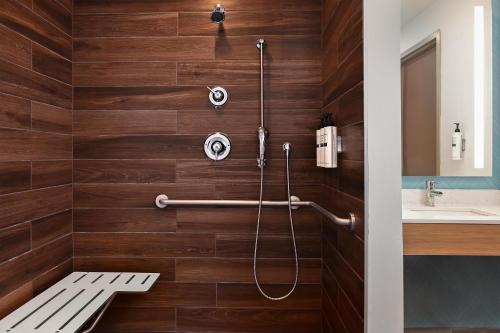 a bathroom with a shower with wooden walls at Hilton Garden Inn Las Vegas Strip South in Las Vegas