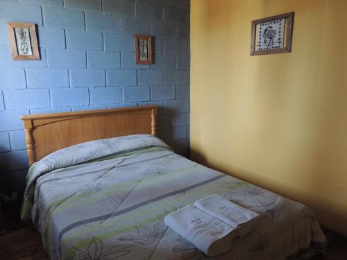 a bedroom with a bed with two towels on it at Aramis in Chascomús