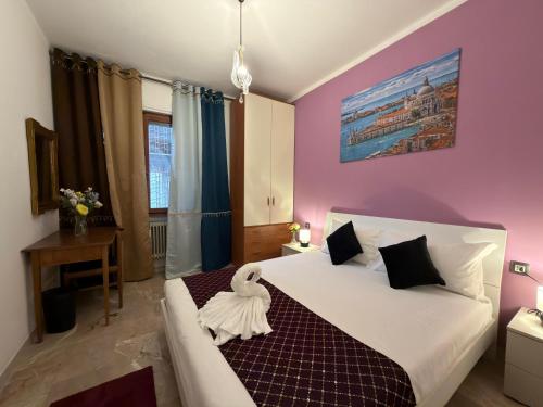 a bedroom with a white bed with a towel on it at CA'venezia in Mestre
