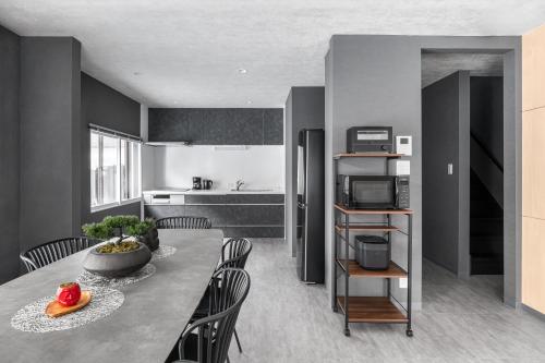 a kitchen and dining room with a table and chairs at The Elements in Nakafurano