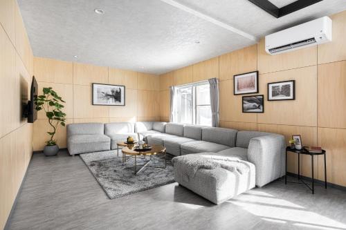 a living room with a couch and a table at The Elements in Nakafurano