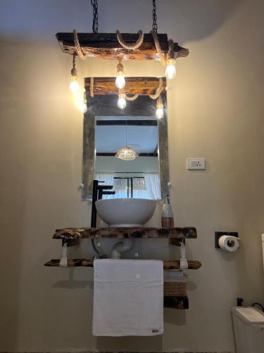 a bathroom with a white sink and a window at Ginhawa Stay Private Pool Studio in Burgos