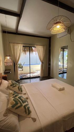 a bedroom with two beds and a view of the beach at Ginhawa Stay Private Pool Studio in Burgos