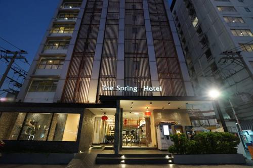 a building with a sign that reads the spring hotel at The Spring Bangkok in Bangna